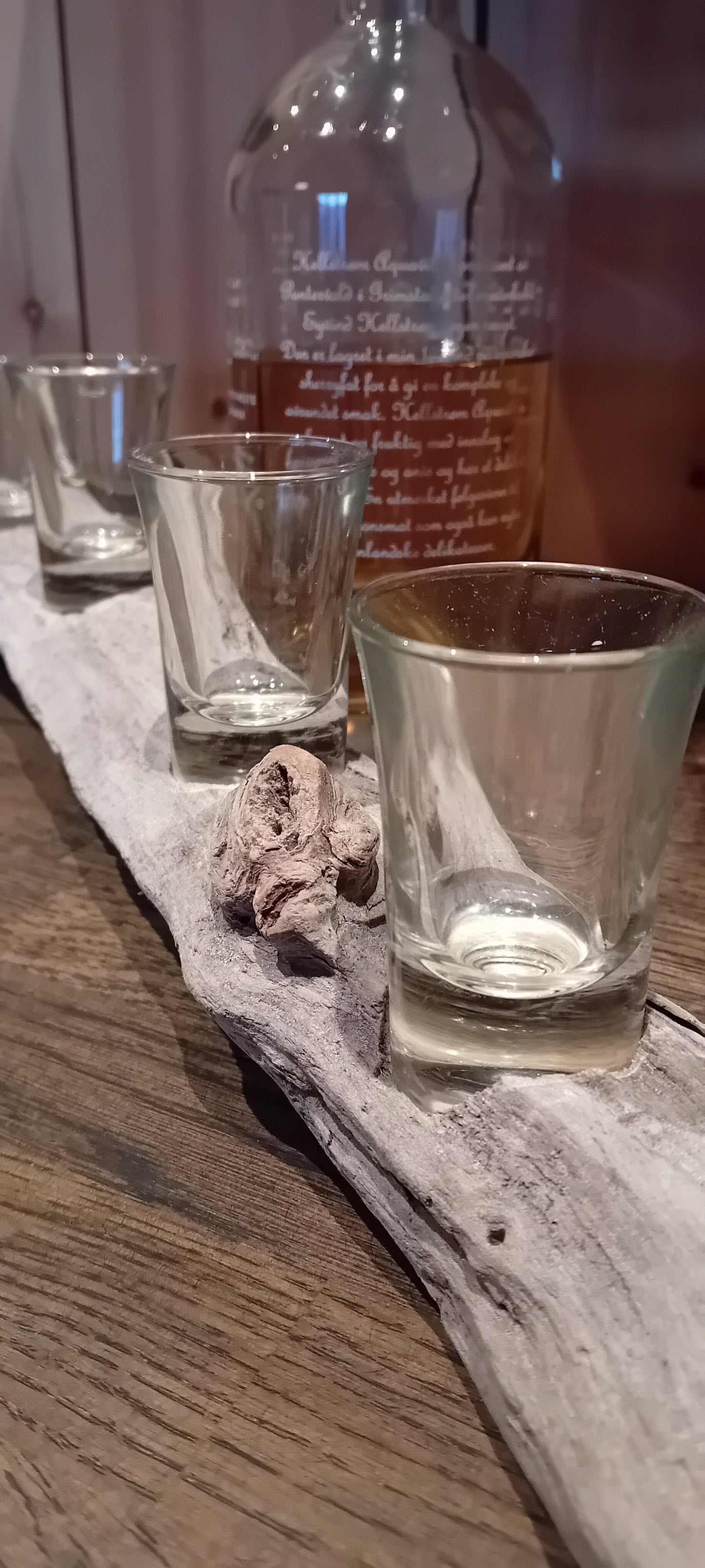 Shot stand made of dried, grayed driftwood.